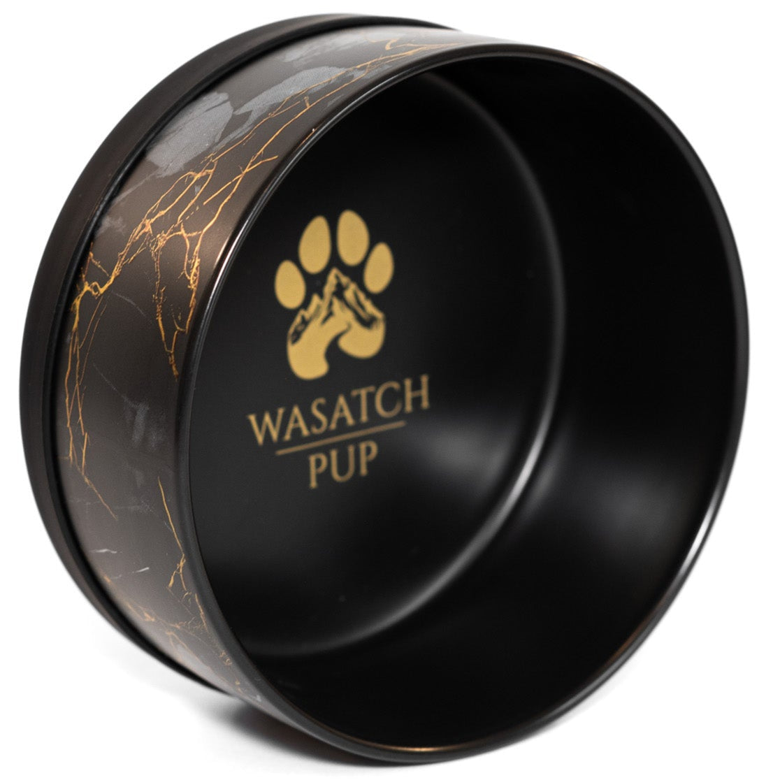 A ceramic dog bowl with a black and gold marble engraved design and the brand 'WASATCH PUP' visible on the side.
