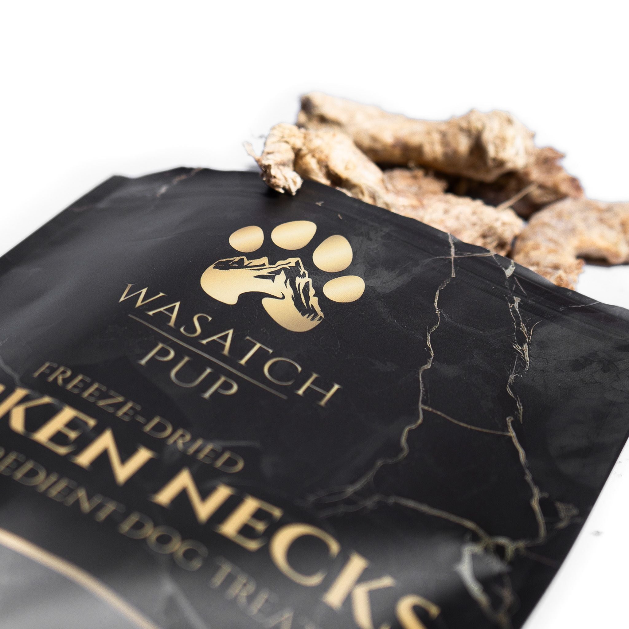 Wasatch Pup freeze-dried chicken neck single ingredient dog treats in black packaging with gold logo.